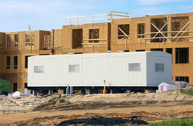 workers studying blueprints in a temporary rental office in Ellenton